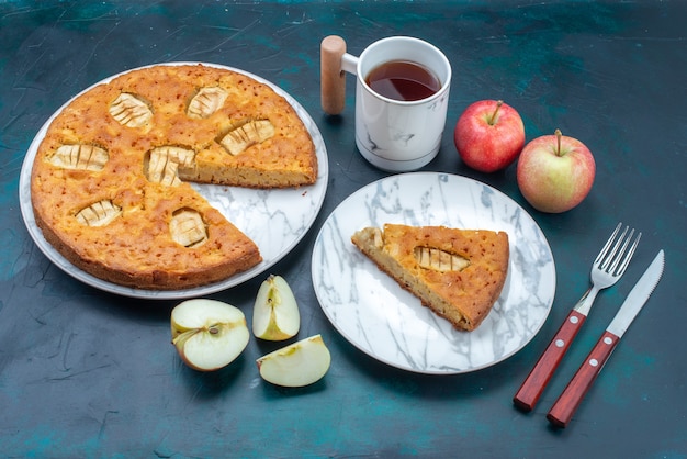 Top view delicious apple pie sliced and whole with tea apples on the dark background fruit cake pie sugar sweet