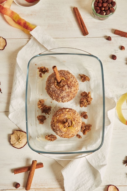 Free Photo top view of delicious baked apple with nuts and cinnamon on a white table