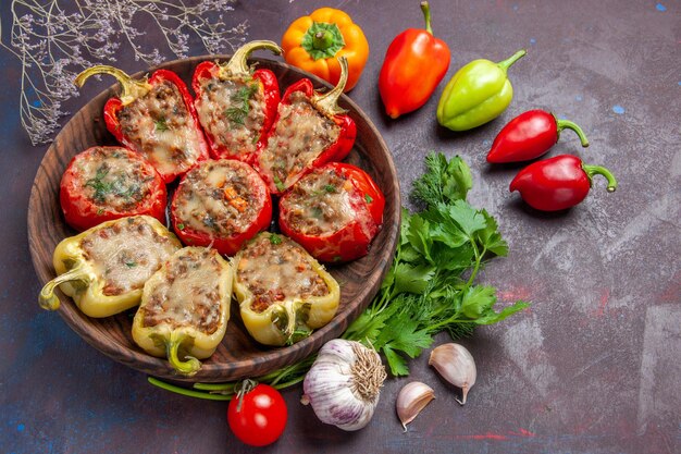 Top view delicious bell-peppers baked dish with mincemeat and vegetables on dark background dinner food bake dish meat