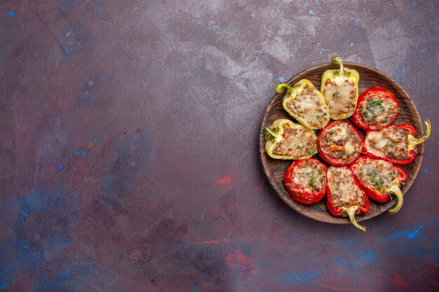 Top view delicious bell-peppers tasty cooked dish with meat on dark background dinner dish meat bake food