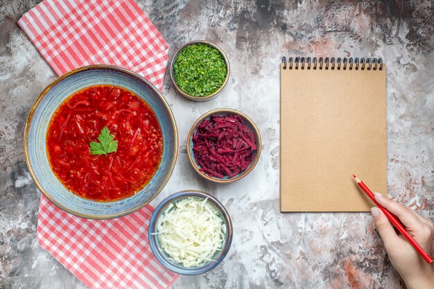 Top view delicious borsch ukrainian beet soup inside plate on white desk