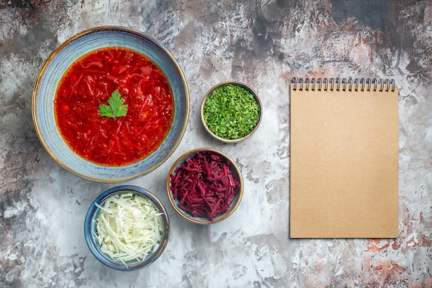 Free photo top view delicious borsch ukrainian beet soup with fresh cabbage and greens on a white background