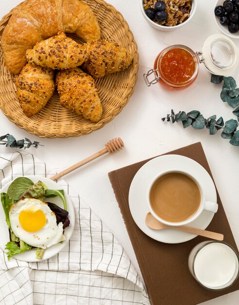 Top view delicious breakfast with croissants and coffee