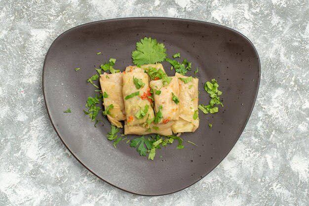 Top view delicious cabbage dolma consists of ground meat with greens on white background meat dinner calorie oil dish food