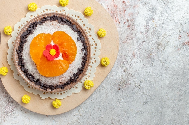 Top view delicious cake dessert with sliced tangerines on the white background fruit cake dessert biscuit cream