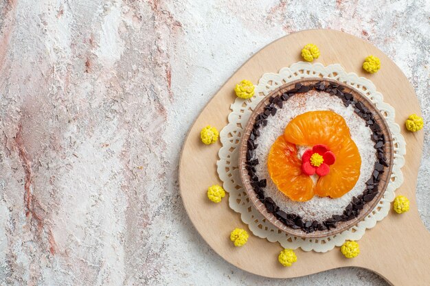 Top view delicious cake dessert with sliced tangerines on white background fruits cake dessert biscuit cream