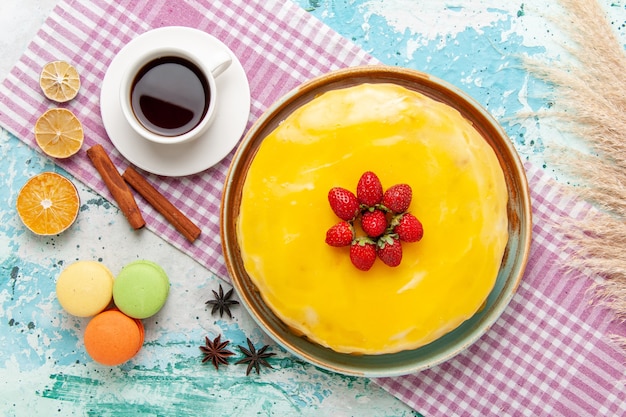 Free photo top view delicious cake with cup of tea on the blue surface biscuit cake sweet pie cookies sugar tea