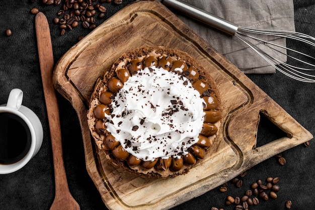 Free photo top view of delicious cake with whisk and coffee