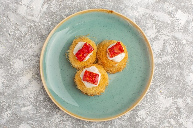 Top view of delicious cake with white cream and red marmalade