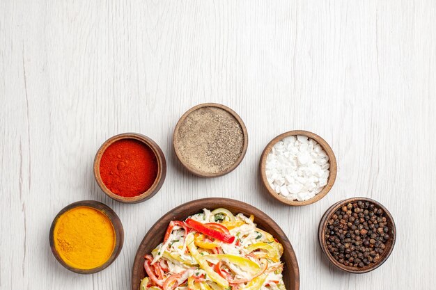 Top view delicious chicken salad with different seasonings on white desk snack ripe meal color meat fresh salad