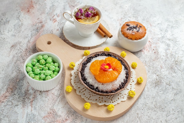 Top view delicious chocolate dessert with cup of tea on the white background cream biscuit cake fruit dessert