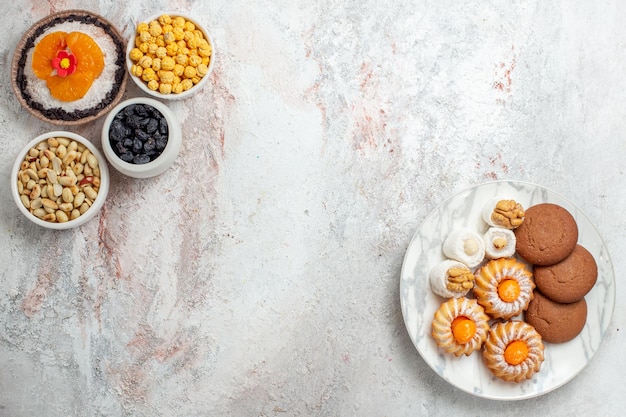 Top view delicious chocolate dessert with nuts and raisins on a white background nut snack dessert cake