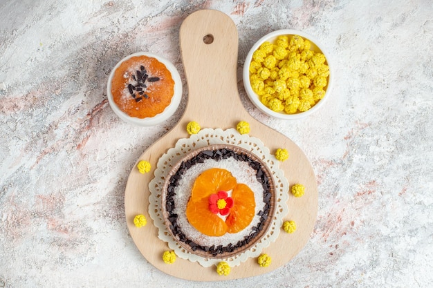 Top view delicious chocolate dessert with sliced tangerines on white background dessert biscuit cream cake fruit