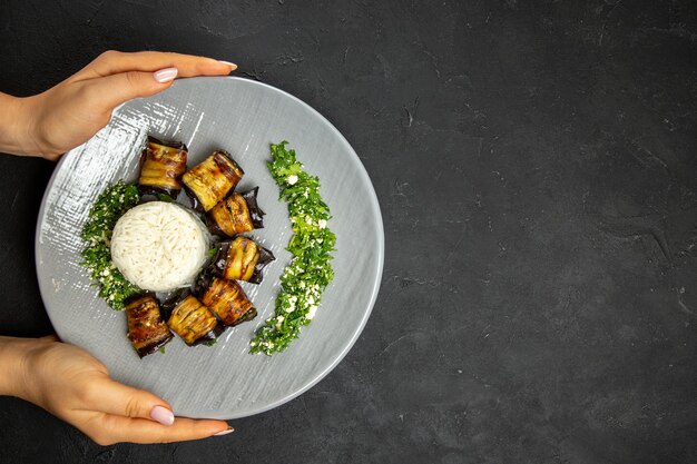 Top view delicious cooked eggplants with rice on dark surface dinner food cooking rice meal