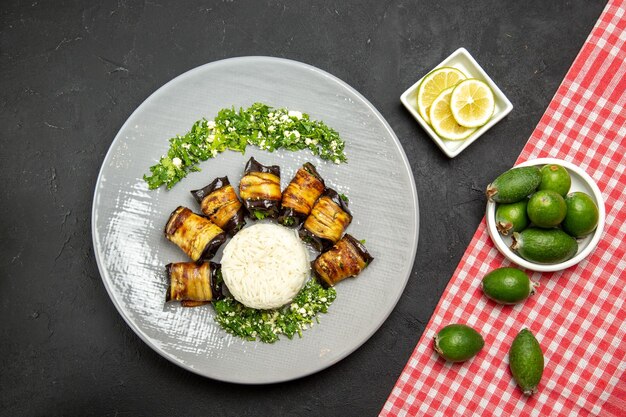 Top view delicious cooked eggplants with rice and feijoa on dark surface dinner food cooking rice meal