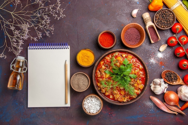 Free Photo top view delicious cooked vegetables sliced with different seasonings on a dark background soup meal food sauce