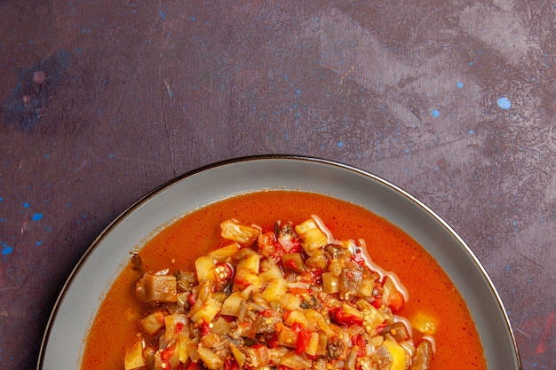 Top view delicious cooked vegetables sliced with sauce on a dark background sauce soup meal vegetable food