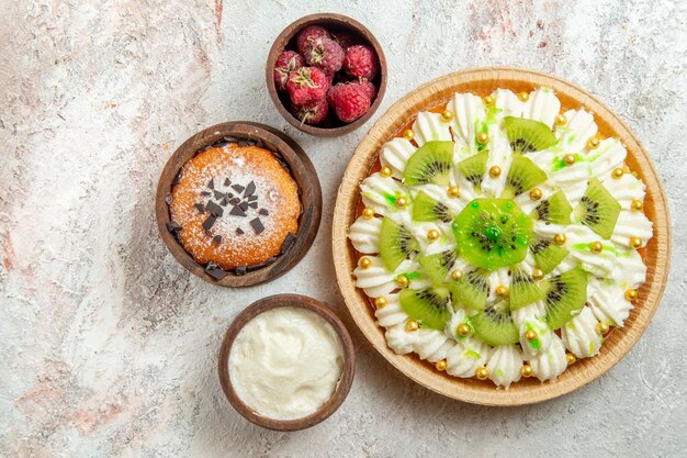 Top view delicious dessert with white cream on white background dessert cream fruit cake candy