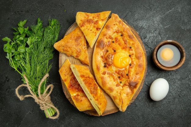 Top view delicious egg bread baked with greens on a grey space