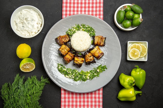 Top view delicious eggplant rolls cooked dish with rice on dark desk cooking rice plant oil food cuisine