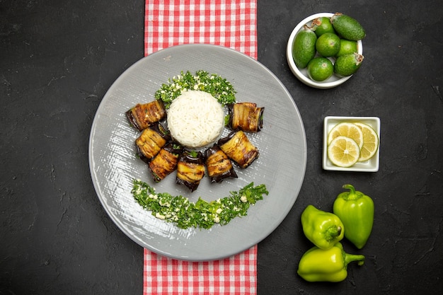 Top view delicious eggplant rolls cooked dish with rice on a dark surface cooking rice plant oil food cuisine