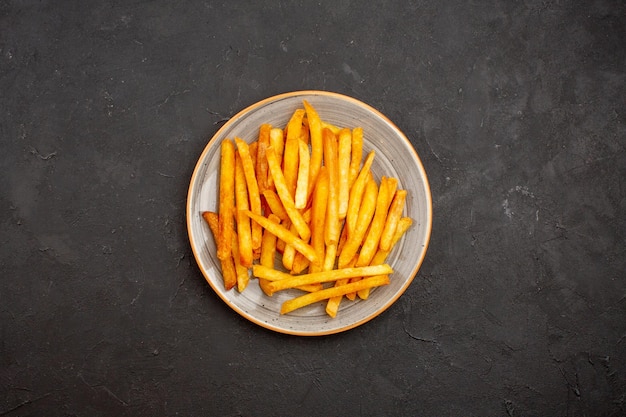 Top view delicious french fries inside plate on a dark background potato burger meal sandwich dinner dish