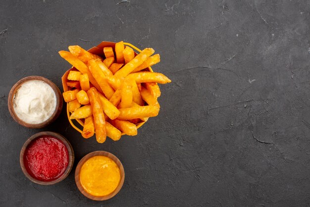 Top view delicious french fries with seasonings on dark background fast-food potato dish burger meal