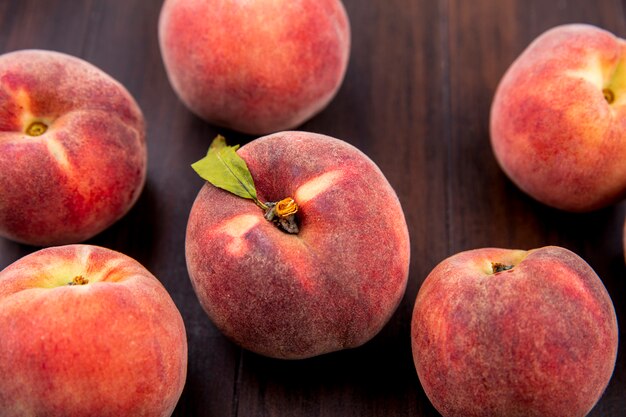 Top view of delicious fresh and juicy peaches isolated on wood