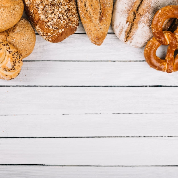 Top view of delicious freshly baked bread on wooden background