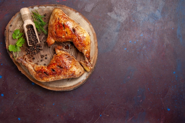 Top view delicious fried chicken with pepper on dark space