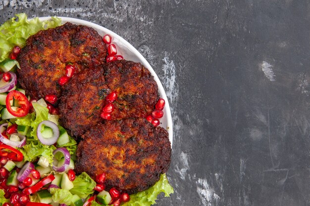 Top view delicious fried cutlets with fresh salad