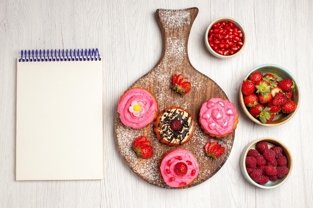 Top view delicious fruit cakes creamy desserts with berries and fruits on a white background cream sweet cookie dessert cake tea