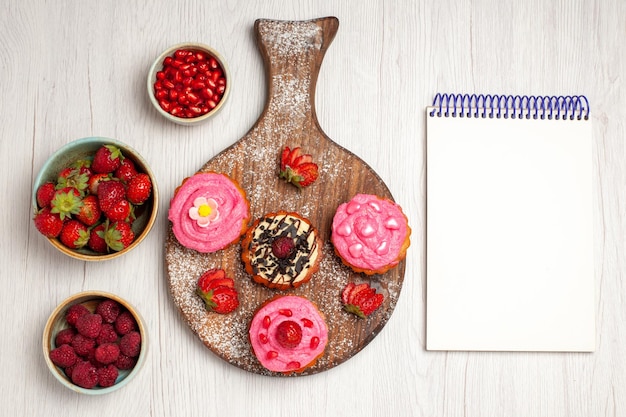 Free Photo top view delicious fruit cakes creamy desserts with berries and fruits on white background cream tea sweet cookie dessert cake