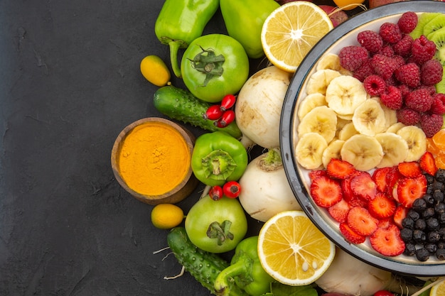 Top view delicious fruit salad inside plate with fresh fruits on a gray tropical fruit tree exotic ripe diet photo