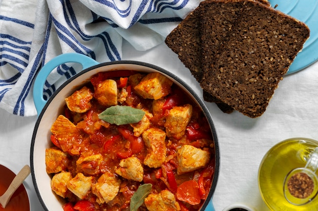 Free Photo top view delicious goulash and bread still life