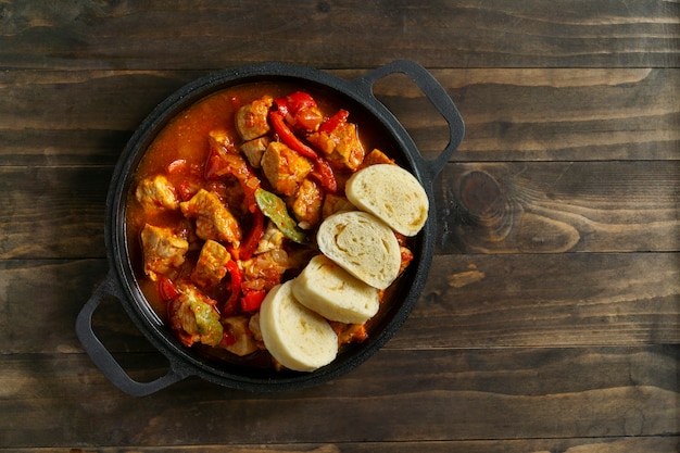 Top view delicious goulash on wooden table