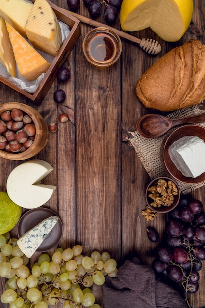 Top view delicious gourmet cheese with bread and grapes