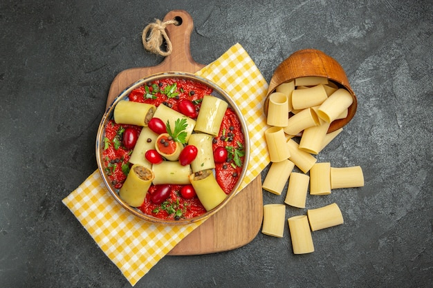 Top view delicious italian pasta with meat and tomato sauce on the dark grey surface meal pasta food dinner dough