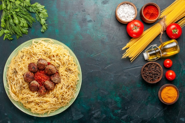 Top view delicious italian pasta with meatballs and tomato sauce on the dark blue desk dough pasta dish meat food italy