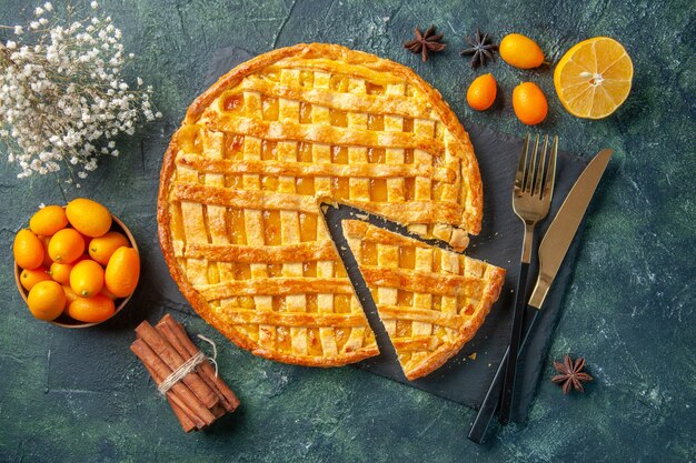 top view delicious kumquat pie with sliced one piece on dark background