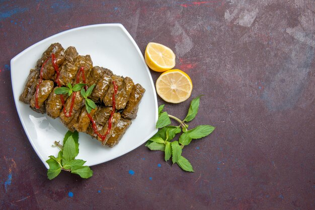 Top view delicious leaf dolma ground meat dish inside plate on dark background dish leaf dinner food meat