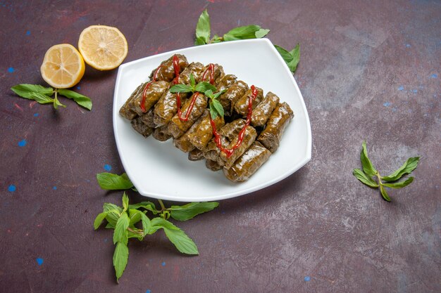 Top view delicious leaf dolma ground meat dish inside plate on the dark background meat dish leaf dinner food