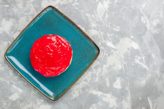 Top view delicious looking cake little pie with red cream on the light white background cake biscuit bake cream sugar sweet