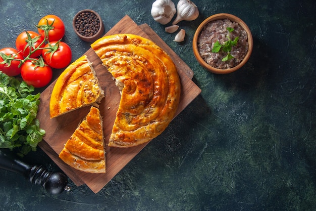 Free Photo top view of delicious meat pie with ingredients on dark surface