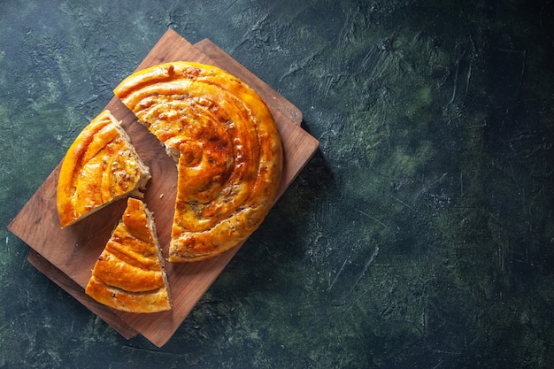 Top view of delicious meat pie on wooden board