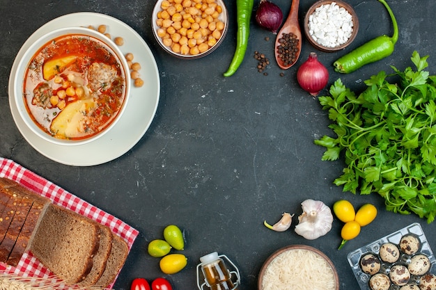 Top view delicious meat soup consists of potatoes beans and meat on a dark background