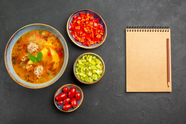 Free photo top view delicious meat soup with sliced pepper on dark table, dish photo meal food