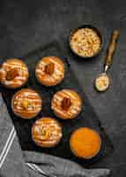 Free photo top view of delicious muffins with nuts on cooling rack