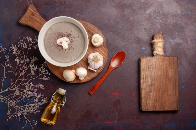 Top view delicious mushroom soup with fresh mushrooms and oil on a dark desk