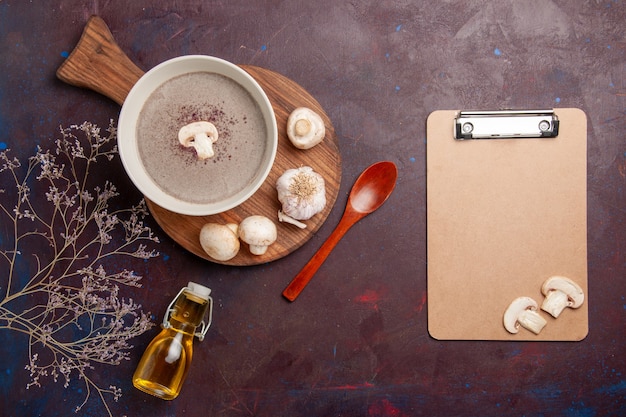 Free photo top view delicious mushroom soup with fresh mushrooms and oil on dark desk